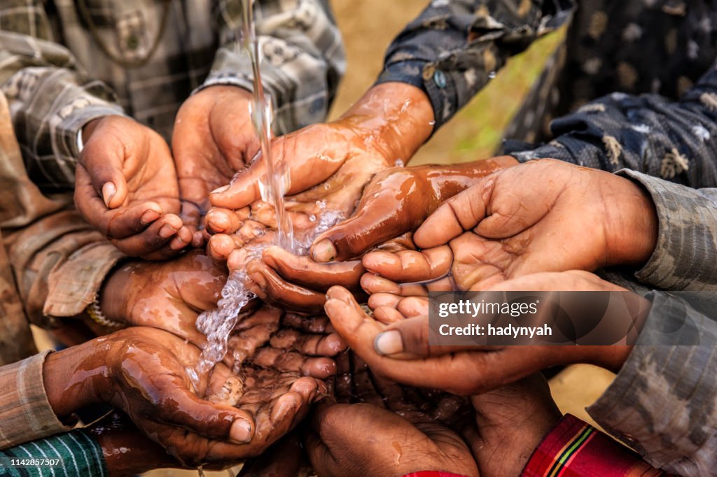 Hands of poor - African children asking for drinking water