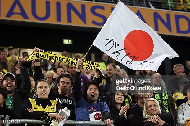 Fans of Japan celebrate their team during the charity match between Borussia Dortmund and a Team of Japan at the Schauinsland Reisen Arena on May 17,...