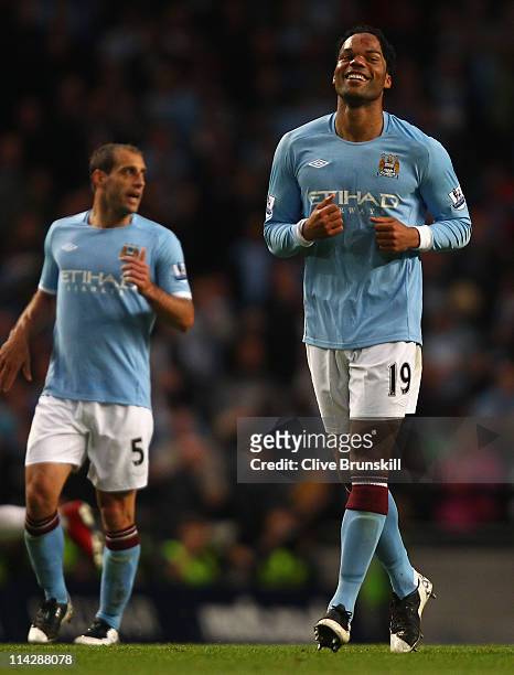 Joleon Lescott of Manchester City smiles as he runs back down the pitch after scoring the second goal during the Barclays Premier League match...
