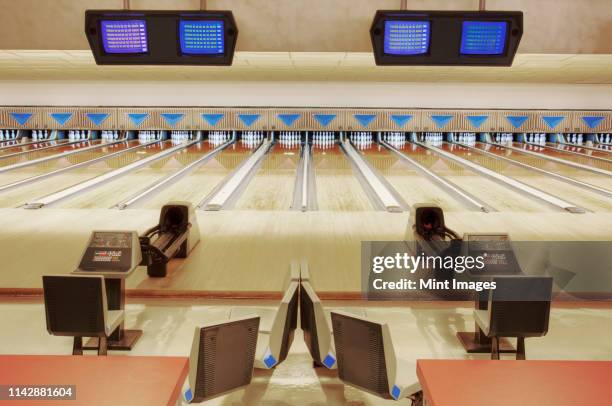 empty lanes in bowling alley - bowling stock-fotos und bilder