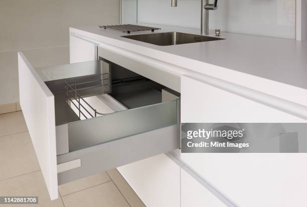 open drawer in modern kitchen - schublade stock-fotos und bilder