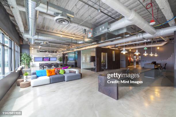 sofas in open office seating area - open concept office stock pictures, royalty-free photos & images