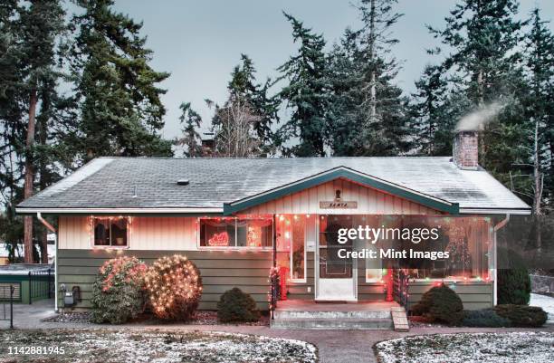 snowy house with christmas lights - christmas decoration outdoor stock pictures, royalty-free photos & images