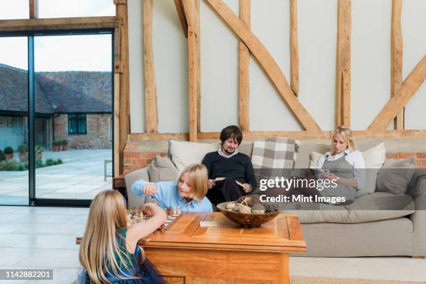 caucasian family relaxing in living room - dadaism stock pictures, royalty-free photos & images