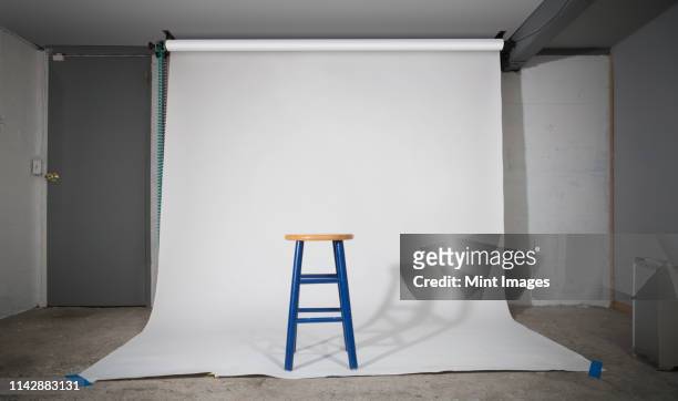 simple stool on sweep in studio - stool stock pictures, royalty-free photos & images
