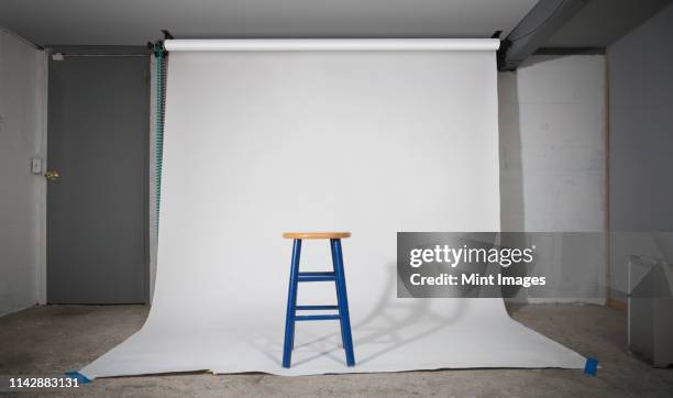 simple stool on sweep in studio - assento imagens e fotografias de stock