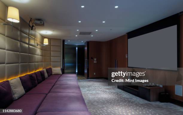 couch and screen in home theater room - home theatre stock pictures, royalty-free photos & images