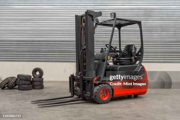 forklift machinery parked in warehouse - forklift truck stock pictures, royalty-free photos & images