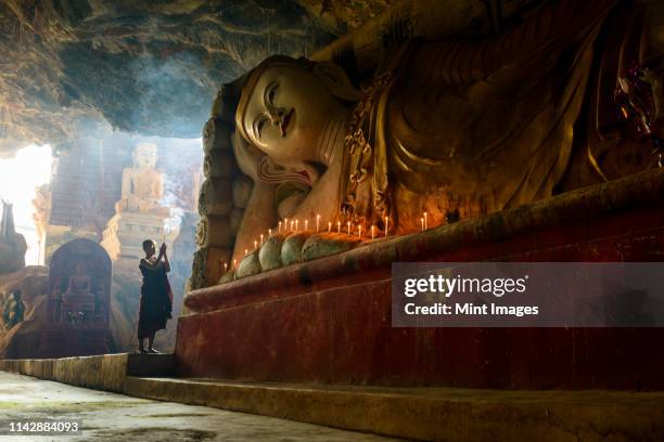 asian monk lighting incense in temple - cleric stock pictures, royalty-free photos & images