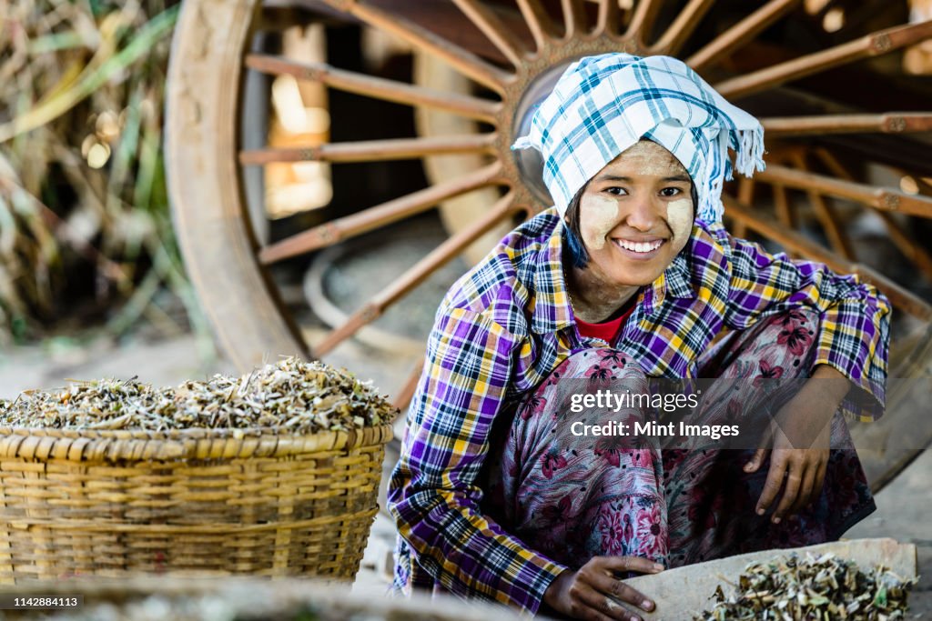 Asian girl selling herbs in market