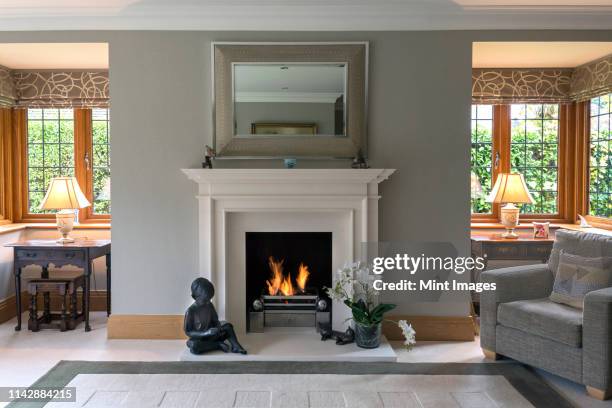 fireplace and armchair living room - canna fumaria foto e immagini stock