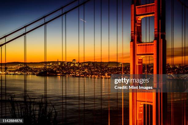 golden gate bridge and san francisco skyline lit up at night, san francisco, california, united states - golden gate bridge night stock pictures, royalty-free photos & images