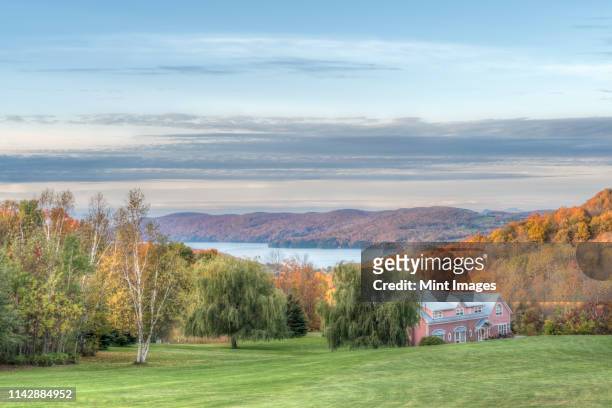 bed and breakfast overlooking autumn leaves and lake - lake massawippi stock pictures, royalty-free photos & images