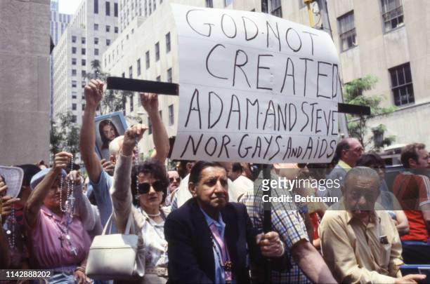 Anti-gay demonstrators stand at the police barrier holding signs protesting homosexuality on a religious basis. They are protesting the Gay...