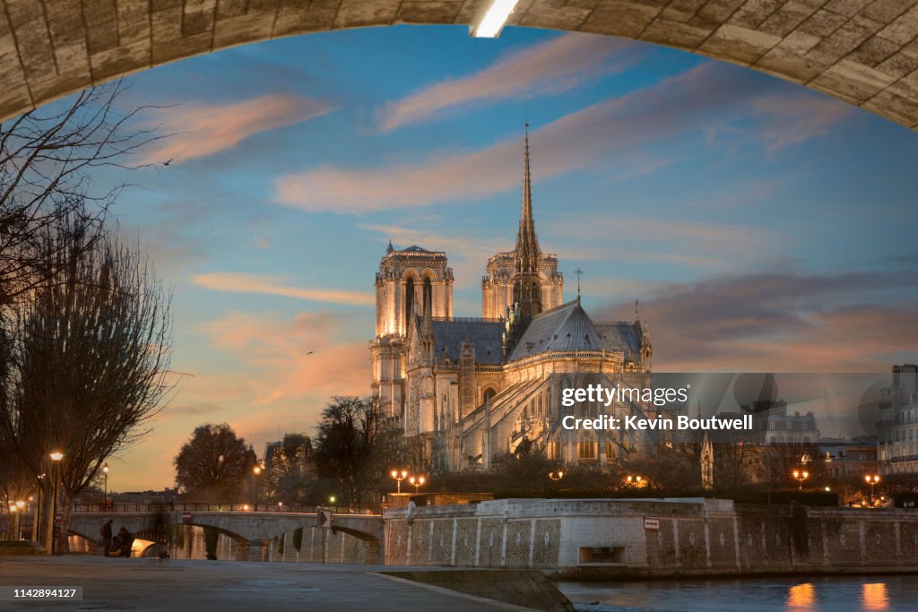 The Iconic Notre Dame Cathedral rises above the Seine