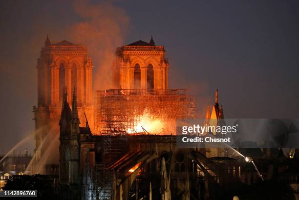 Flames and smoke are seen billowing from the roof at Notre-Dame Cathedral on April 15, 2019 in Paris, France. A fire broke out on Monday afternoon...