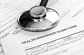 Stethoscope on health insurance claim form. Close up.