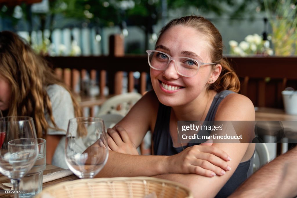 Young woman enjoying leisure time at restaurant terrace.