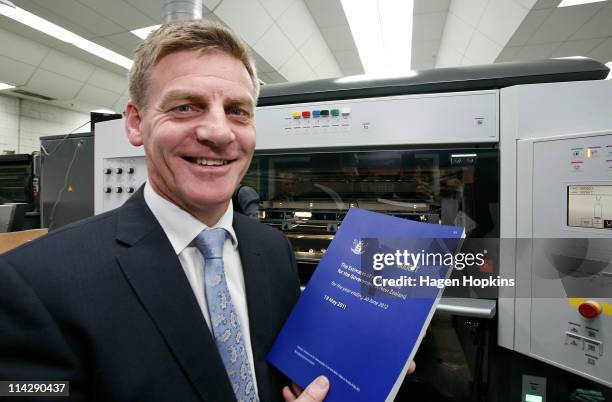 Finance Minister Bill English poses with a copy of the 2011 budget at Printlink during the printing of the budget on May 18, 2011 in Wellington, New...