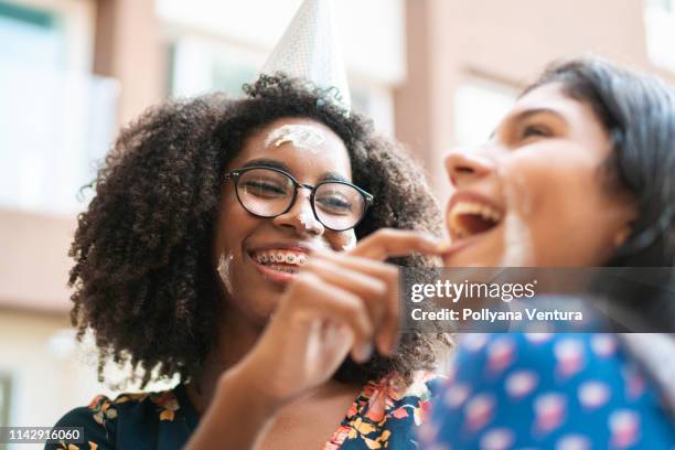 cake in the face on birthday party - food fight stock pictures, royalty-free photos & images