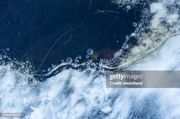 frozen air bubbles in ice - macro photography stock pictures, royalty-free photos & images