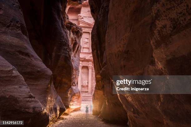 two people standing in gorge by the treasury, petra, jordan - jordan or jordanian or the hashemite kingdom of jordan people or citizens ストックフォトと画像