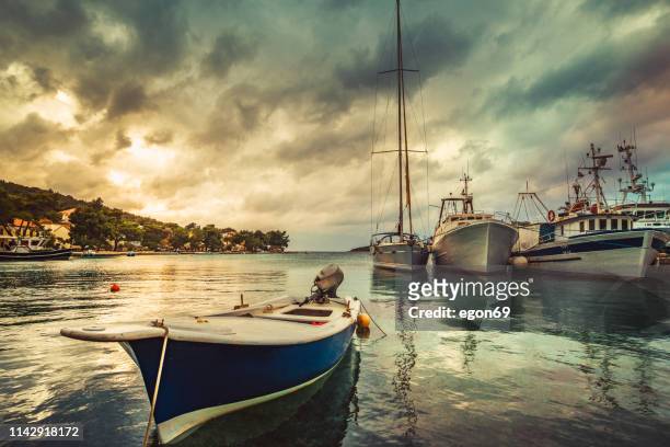 boats moored at small marina - moored stock pictures, royalty-free photos & images