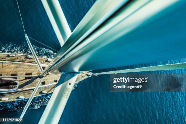 sailing boat in deep blue sea - aluminium boat stock pictures, royalty-free photos & images