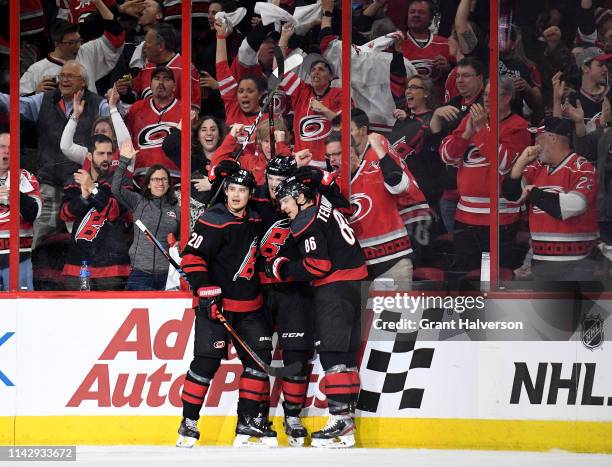 Warren Foegele celebrates with Sebastian Aho and Teuvo Teravainen of the Carolina Hurricanes after scoring a goal against the Washington...