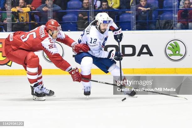 Oliver Lauridsen of Denmark checks Valentin Claireaux of France during the 2019 IIHF Ice Hockey World Championship Slovakia group A game between...