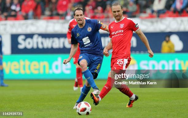 Bjoern Jopek of Halle challenges for the ball with Stephan Fuerstner of Braunschweig during the 3. Liga match between Hallescher FC and Eintracht...