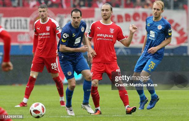 Bjoern Jopek of Halle challenges for the ball with Stephan Fuerstner of Braunschweig during the 3. Liga match between Hallescher FC and Eintracht...