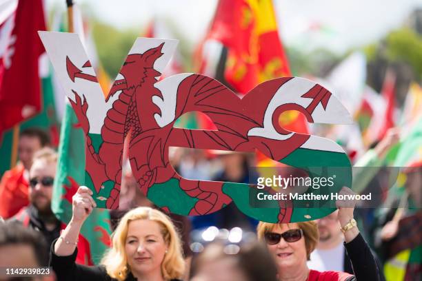 Two women hold a Yes sign as thousands take part in the first ever march for Welsh independence from City Hall to the Hayes on May 11, 2019 in...