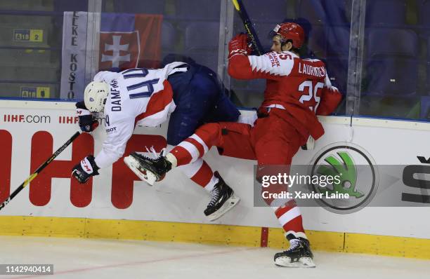 Olivier Dame Malka of France is slash by Oliver Lauridsen of Denmark during the 2019 IIHF Ice Hockey World Championship Slovakia group A game between...