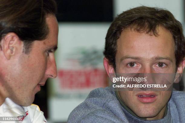Cart drivers Mario Rodriguez of Mexico and Cristian Da Matta of Brazil answer questions during a press conference 14 November 2002 in Mexico City....