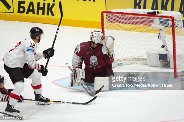 Michael Raffl scores a goal against Goalie Kristers Gudlevskis during the 2019 IIHF Ice Hockey World Championship Slovakia group B game between...
