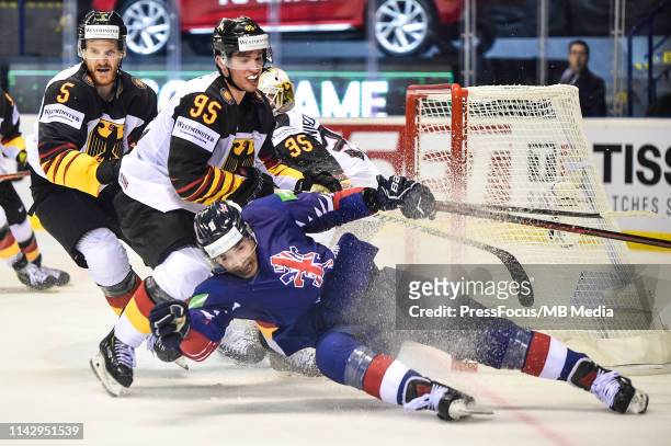 Frederik Tiffels of Germany checks Matthew Myers of Great Britain during the 2019 IIHF Ice Hockey World Championship Slovakia group A game between...