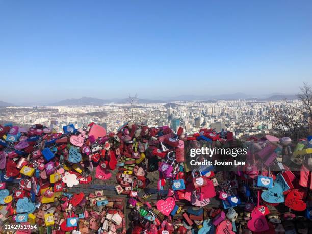 lovelocks in namsan overlooking seoul skyline - kärlekslås bildbanksfoton och bilder