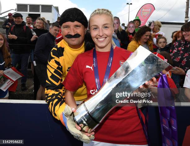 Leah Williamson of Arsenal with the WSL Trophy and a family member dressed as David Seaman after the match between Arsenal Women and Manchester City...