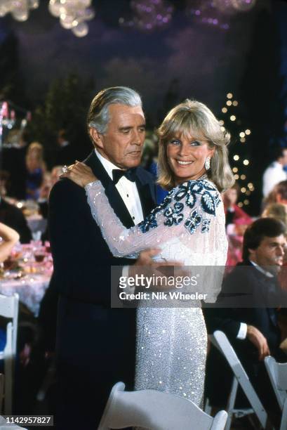 Television actor John Forsythe and co-star actress Linda Evans on the set of TV soap "Dynasty" circa 1984;