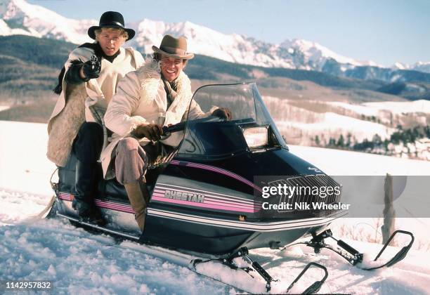 Movie actors Tom Berenger and William Katt ride snowmobile during break in shooting schedule of the movie "Butch and Sundance -- The Early Days"...