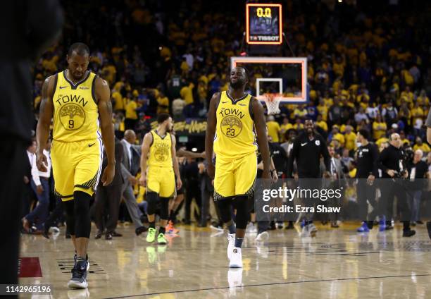 Andre Iguodala and Draymond Green of the Golden State Warriors walk off the court after they lost to the LA Clippers during Game Two of the first...