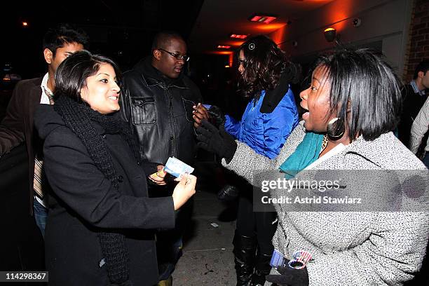 Guests pose for photos during the distribution of Ciroc debit cards for yellow cab fares on New Year's Eve hosted by Ciroc Vodka on December 31, 2008...