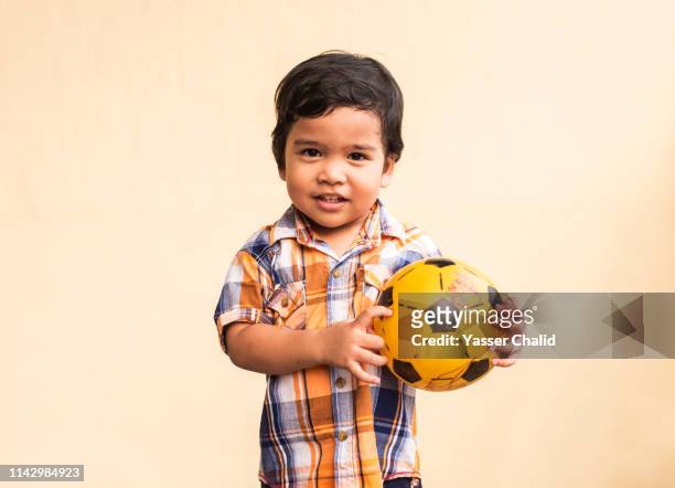 toddler boy portrait with ball - fußball 2 jungs stock-fotos und bilder