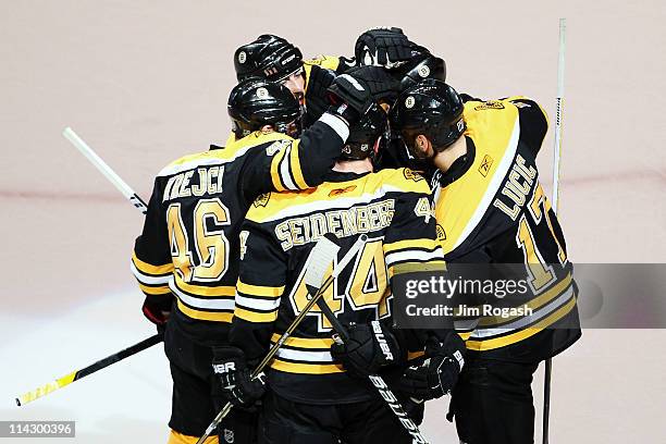 Dennis Seidenberg of the Boston Bruins celebrates his first period goal against the Tampa Bay Lightning with teammates in Game Two of the Eastern...