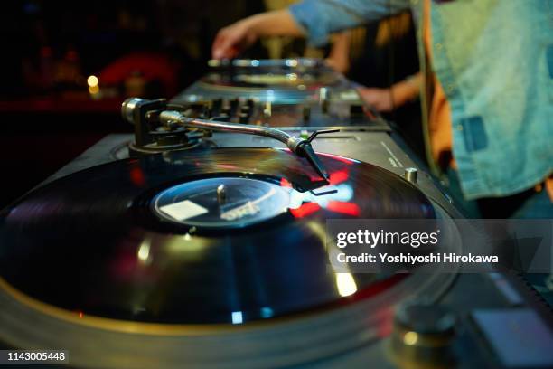 closeup shot of dj mixing music on turntable. - record scratching stock pictures, royalty-free photos & images