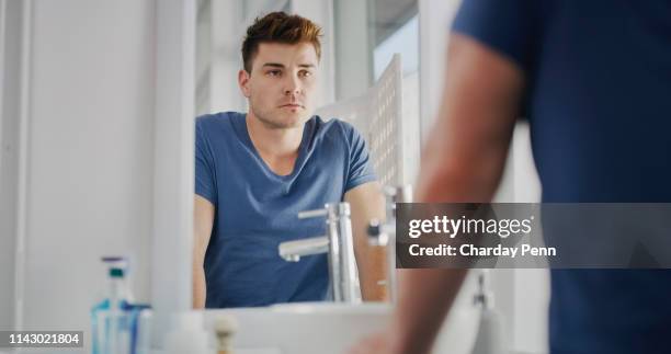 feeling fresh brings confidence - guy looking in mirror stock pictures, royalty-free photos & images
