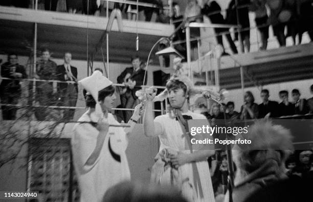 George Harrison and John Lennon of The Beatles pictured together on stage during a rehearsal for the 'Around The Beatles' TV show at the Rediffusion...