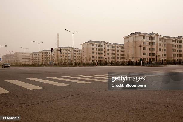 Residential apartment buildings stand in the new district of Kangbashi in Ordos, Inner Mongolia, China, on Friday, April 29, 2011. Designed for...