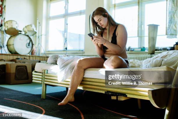 woman checking text messages - buxom blonde stock pictures, royalty-free photos & images